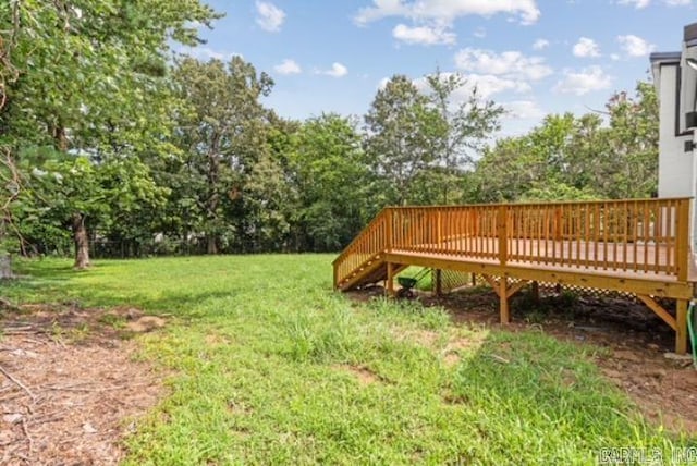 1506 N Pratt St, Pocahontas, AR 72455 - view of green lawn featuring a wooden deck and view of wooded area