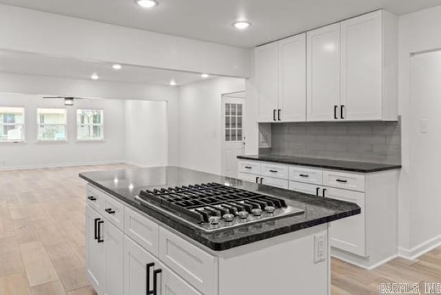 1506 N Pratt St, Pocahontas, AR 72455 - kitchen with stainless steel gas stovetop, light wood-style floors, baseboards, backsplash, and open floor plan