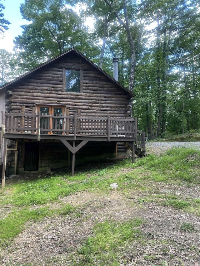 1203 Stewart Rd, Little Rock, AR 72223 - rear view of property with a wooden deck and log siding