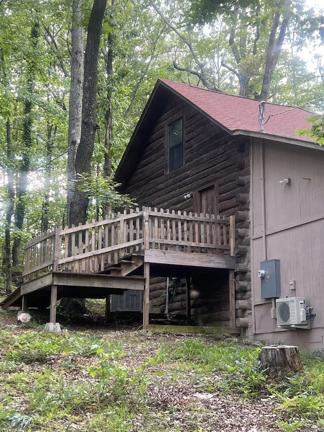 1203 Stewart Rd, Little Rock, AR 72223 - rear view of property featuring a wooden deck, log exterior, ac unit, and a shingled roof