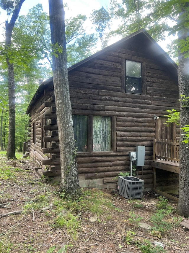 1203 Stewart Rd, Little Rock, AR 72223 - view of property exterior featuring log siding and central AC