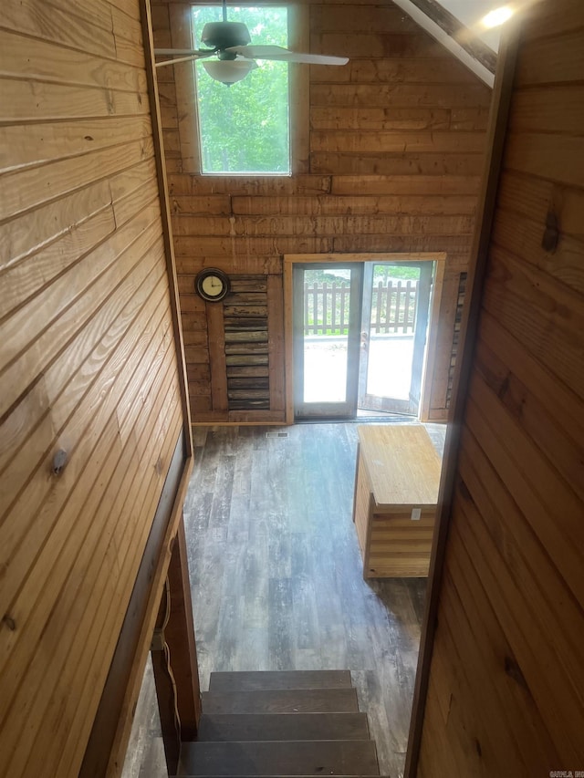 1203 Stewart Rd, Little Rock, AR 72223 - doorway to outside featuring wood walls, ceiling fan, and wood finished floors