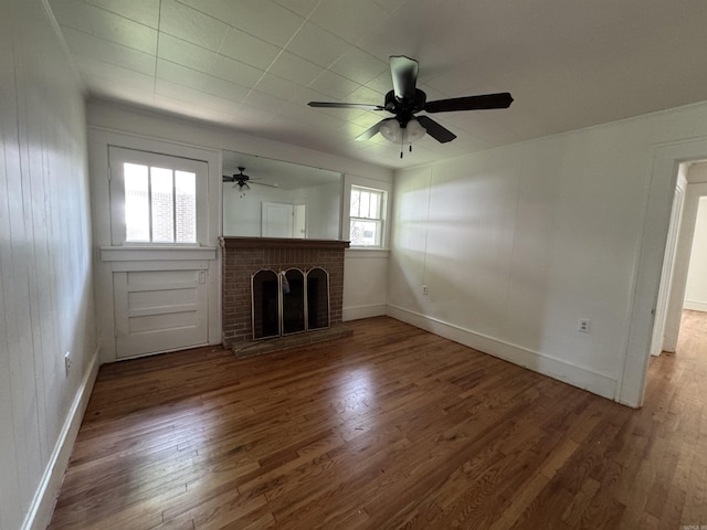 404 Mchenry, Malvern, AR 72104 - unfurnished living room featuring wood finished floors, a ceiling fan, a brick fireplace, and baseboards