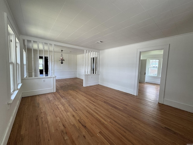 404 Mchenry, Malvern, AR 72104 - unfurnished room with wood finished floors, plenty of natural light, and baseboards