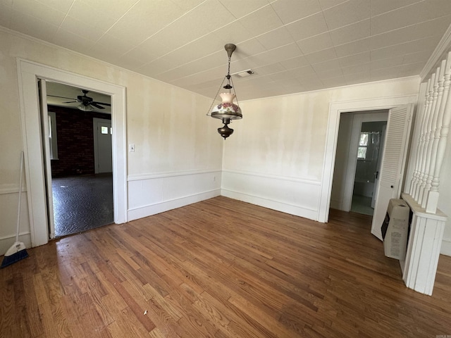 404 Mchenry, Malvern, AR 72104 - unfurnished dining area with wood finished floors, crown molding, ceiling fan, and wainscoting