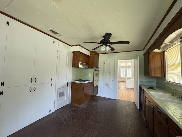 404 Mchenry, Malvern, AR 72104 - kitchen with a sink, oven, ornamental molding, a ceiling fan, and white gas cooktop