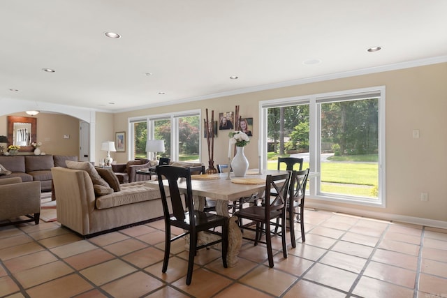 13 Heritage Park Cir, North Little Rock, AR 72116 - dining space with light tile patterned floors, arched walkways, healthy amount of natural light, crown molding, and recessed lighting