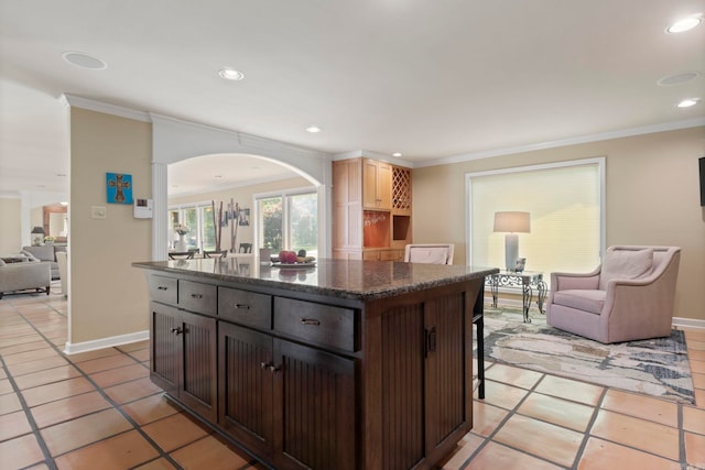 13 Heritage Park Cir, North Little Rock, AR 72116 - kitchen featuring arched walkways, open floor plan, a kitchen bar, ornamental molding, and a center island