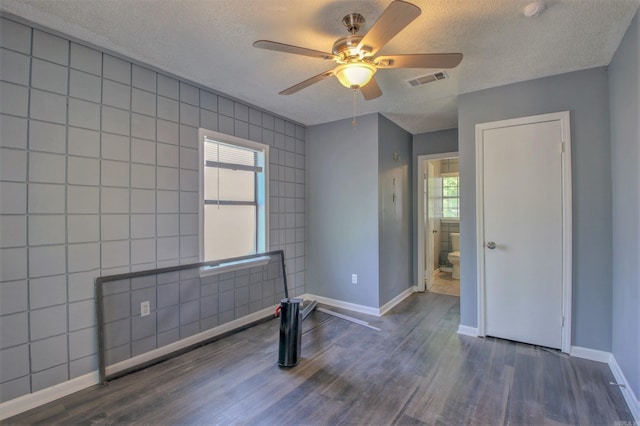 1320 Abigail St, Little Rock, AR 72204 - spare room featuring wood finished floors, a textured ceiling, ceiling fan, and baseboards
