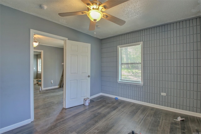 1320 Abigail St, Little Rock, AR 72204 - spare room with baseboards, dark wood-style flooring, and a textured ceiling