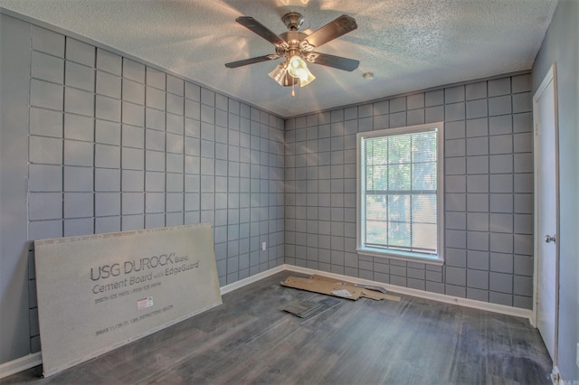 1320 Abigail St, Little Rock, AR 72204 - unfurnished room with wood finished floors, a textured ceiling, a ceiling fan, tile walls, and baseboards