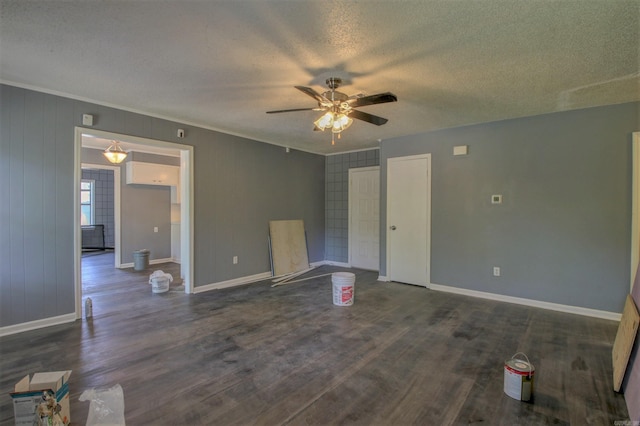 1320 Abigail St, Little Rock, AR 72204 - unfurnished living room with a ceiling fan, a textured ceiling, baseboards, dark wood-style flooring, and ornamental molding