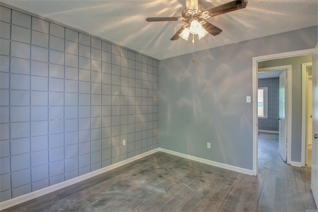 1320 Abigail St, Little Rock, AR 72204 - empty room with ceiling fan, a textured ceiling, dark wood-style floors, and baseboards