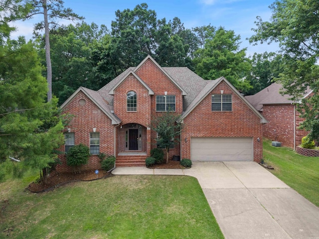5 Cypress Pt, Little Rock, AR 72212 - traditional home featuring brick siding, an attached garage, concrete driveway, a front lawn, and roof with shingles