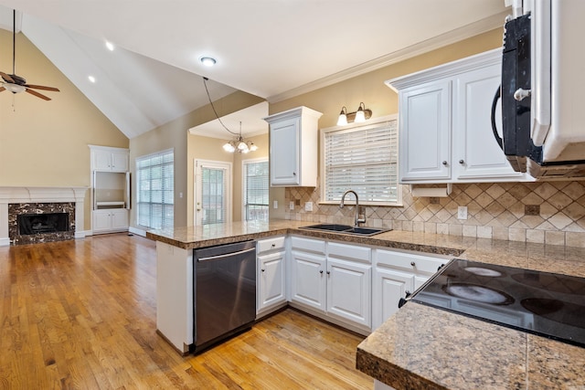 5 Cypress Pt, Little Rock, AR 72212 - kitchen featuring dishwasher, a sink, white microwave, a peninsula, and tile counters