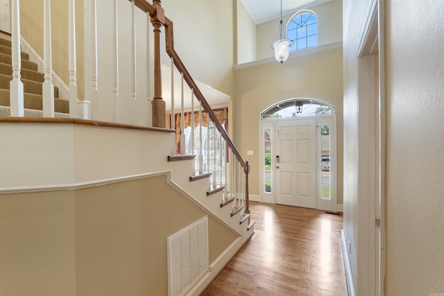 5 Cypress Pt, Little Rock, AR 72212 - foyer with wood finished floors, healthy amount of natural light, stairs, a towering ceiling, and baseboards