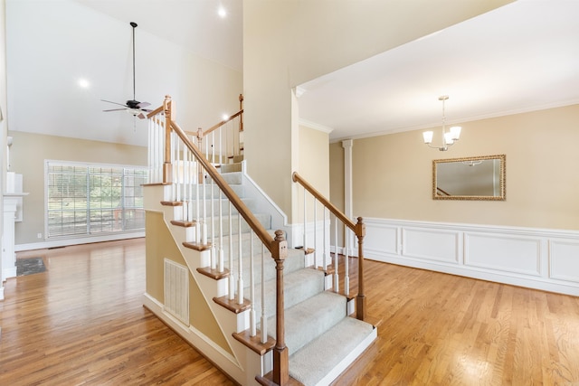 5 Cypress Pt, Little Rock, AR 72212 - stairs featuring wood finished floors, ceiling fan, ornamental molding, a chandelier, and a towering ceiling