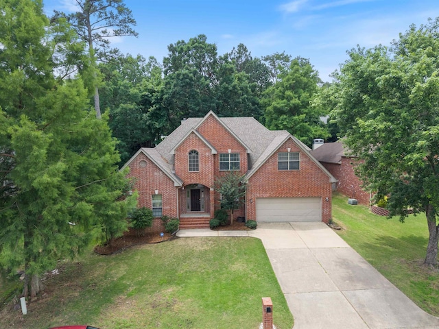 5 Cypress Pt, Little Rock, AR 72212 - traditional-style house featuring driveway, brick siding, an attached garage, and a front lawn
