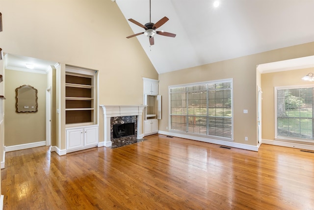 5 Cypress Pt, Little Rock, AR 72212 - unfurnished living room featuring a fireplace, high vaulted ceiling, a ceiling fan, light wood-type flooring, and built in shelves