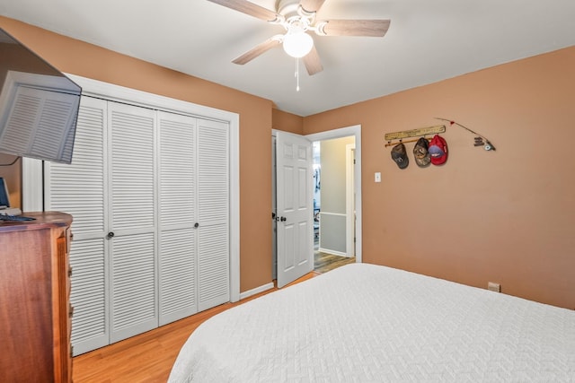 15621 Mail Route Rd, Little Rock, AR 72206 - bedroom with light wood finished floors, ceiling fan, a closet, and baseboards