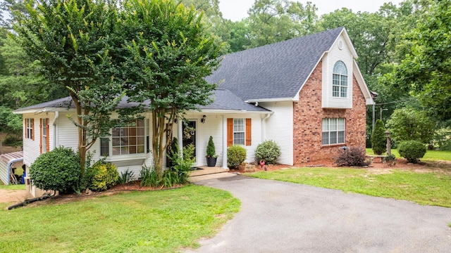 15621 Mail Route Rd, Little Rock, AR 72206 - view of front facade with a front yard, brick siding, and roof with shingles