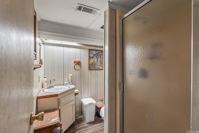 15621 Mail Route Rd, Little Rock, AR 72206 - full bathroom with vanity, toilet, a stall shower, and wood finished floors