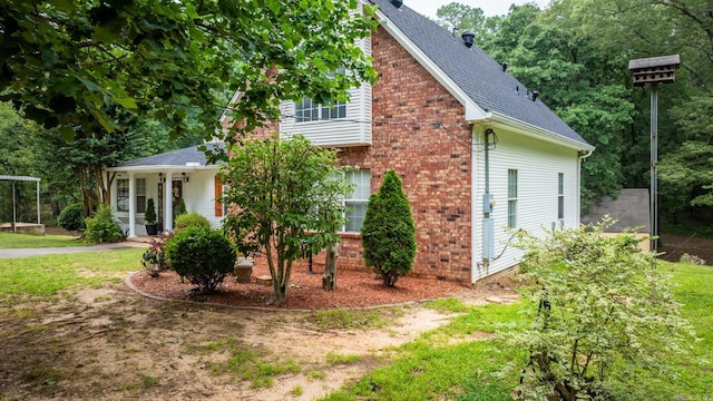 15621 Mail Route Rd, Little Rock, AR 72206 - view of home's exterior featuring a shingled roof and brick siding