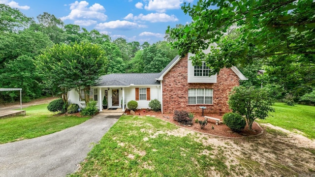 15621 Mail Route Rd, Little Rock, AR 72206 - view of front of home with a front yard, brick siding, and asphalt driveway