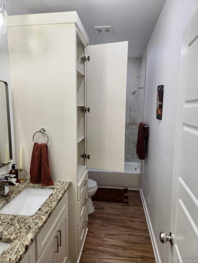 1418 S Martin St, Little Rock, AR 72204 - full bathroom featuring vanity, wood finished floors, toilet, shower / bath combination, and baseboards