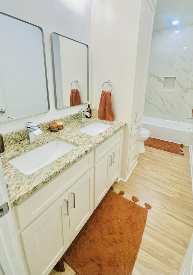 1418 S Martin St, Little Rock, AR 72204 - full bathroom with double vanity, wood finished floors, and toilet