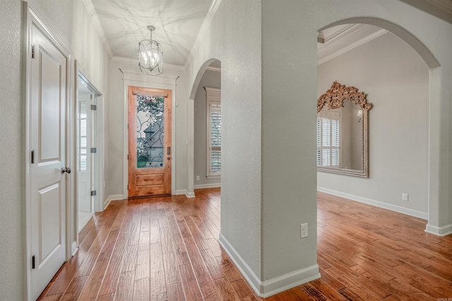 26 Kanis Creek Pl, Little Rock, AR 72223 - entrance foyer with arched walkways, ornamental molding, hardwood / wood-style floors, a chandelier, and baseboards