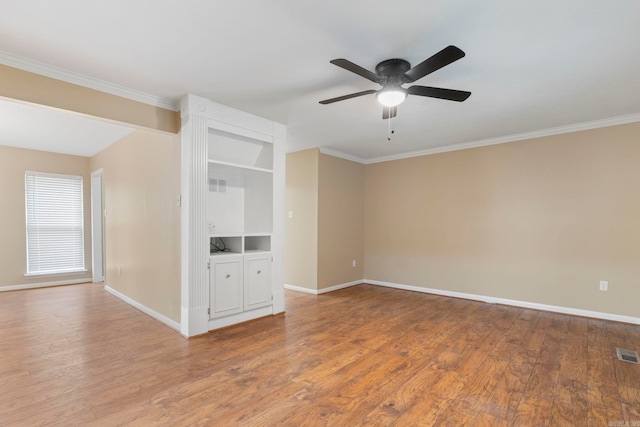 3017 Delmar Ave, North Little Rock, AR 72116 - spare room featuring a ceiling fan, baseboards, wood finished floors, and crown molding