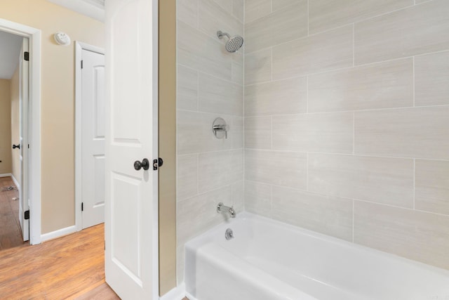 3017 Delmar Ave, North Little Rock, AR 72116 - bathroom with shower / tub combination, wood finished floors, and baseboards