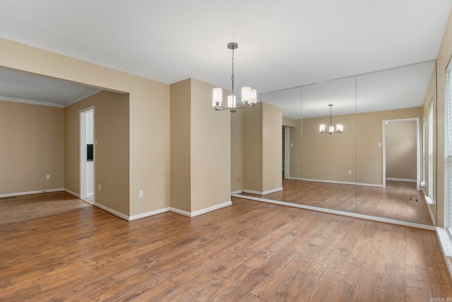 3017 Delmar Ave, North Little Rock, AR 72116 - unfurnished room featuring a chandelier, wood finished floors, baseboards, and ornamental molding