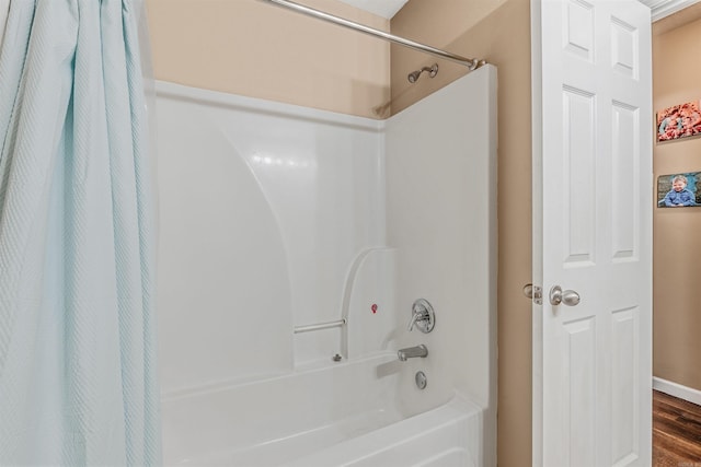 43 Juanita Cv, Lonoke, AR 72086 - bathroom with shower / bath combination with curtain and wood finished floors