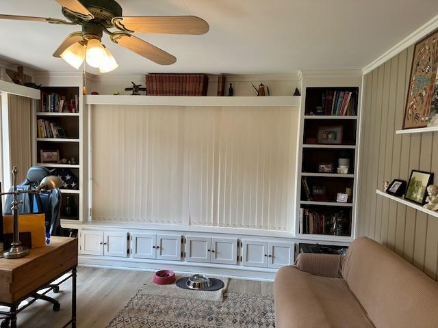 1803 Fairwater Cir, Horseshoe Bend, AR 72512 - living room featuring wood finished floors, ceiling fan, and wooden walls