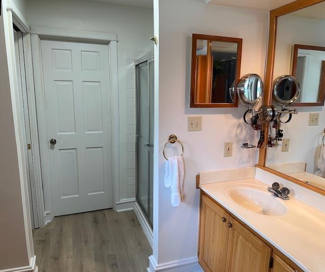 1803 Fairwater Cir, Horseshoe Bend, AR 72512 - full bathroom with wood finished floors, a stall shower, and vanity
