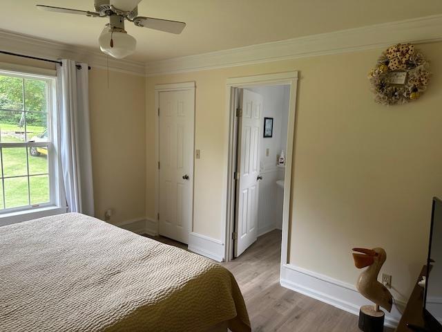 1803 Fairwater Cir, Horseshoe Bend, AR 72512 - bedroom featuring ornamental molding, light wood-style floors, baseboards, and ceiling fan