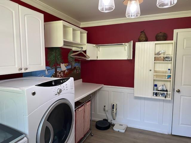 1803 Fairwater Cir, Horseshoe Bend, AR 72512 - laundry room with cabinet space, washer and clothes dryer, crown molding, wood finished floors, and a wainscoted wall