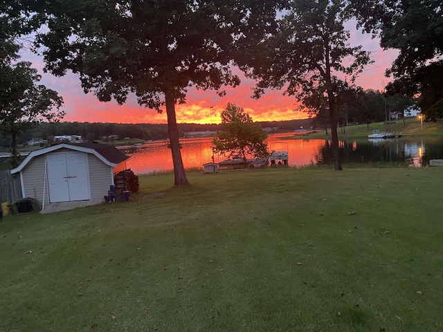 1803 Fairwater Cir, Horseshoe Bend, AR 72512 - yard at dusk featuring a water view and a yard