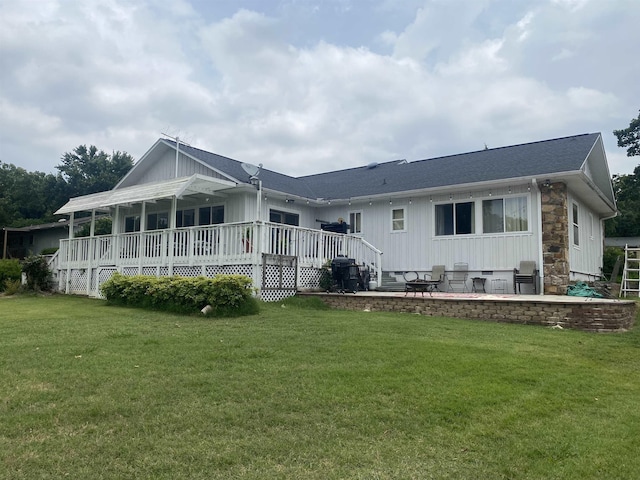 1803 Fairwater Cir, Horseshoe Bend, AR 72512 - back of property featuring stone siding, a lawn, board and batten siding, and a deck