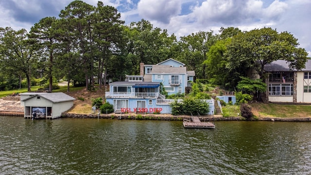 rear view of property featuring a water view and stairs