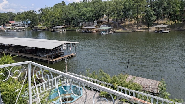 dock with a water view and view of scattered trees