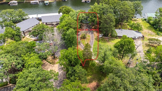 aerial view of property and surrounding area featuring a large body of water and property parcel outlined