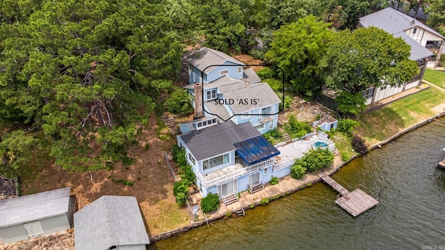 aerial view of property and surrounding area with a large body of water