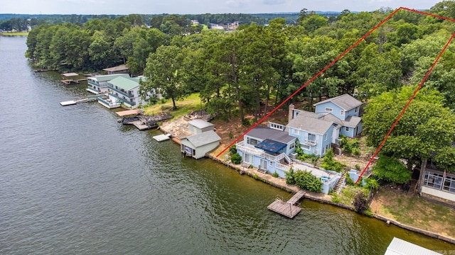 aerial view of property and surrounding area featuring a nearby body of water and property parcel outlined
