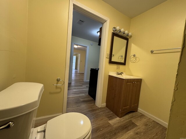 1316-1318 W 13th St, Little Rock, AR 72202 - half bath featuring toilet, wood finished floors, vanity, and baseboards