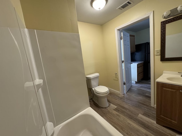 1316-1318 W 13th St, Little Rock, AR 72202 - bathroom featuring wood finished floors, vanity, toilet, and baseboards