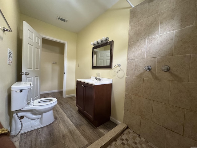 1316-1318 W 13th St, Little Rock, AR 72202 - bathroom featuring wood finished floors, vanity, a tile shower, and toilet