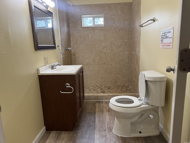 1316-1318 W 13th St, Little Rock, AR 72202 - full bathroom with vanity, toilet, wood finished floors, a tile shower, and baseboards